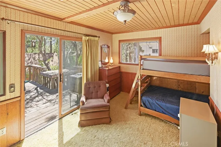 Large bedroom at back of house with direct access to backyard deck.