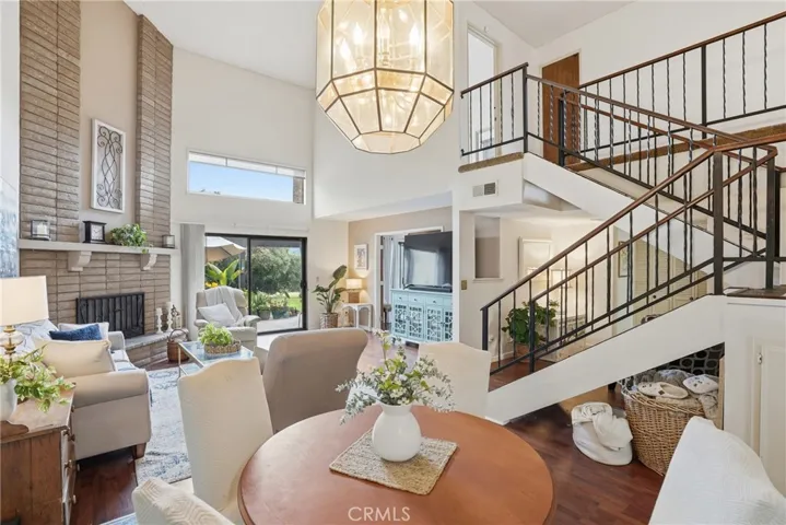 Dining Area, Stairway To Upper Level And Living Room In Background