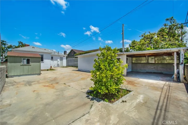 Far right covered space behind garage