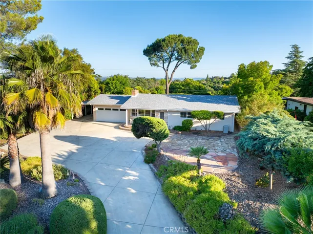 Established landscape around a large driveway with ample parking.