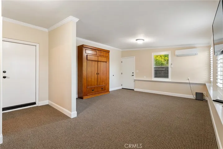 Guest Bedroom with separate entrance has Murphy Bed and matching armoire included