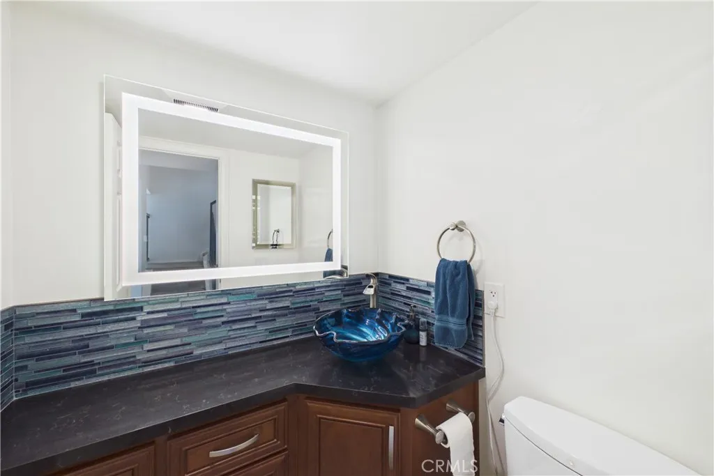 Powder bath with a lit mirror and Toto toilet