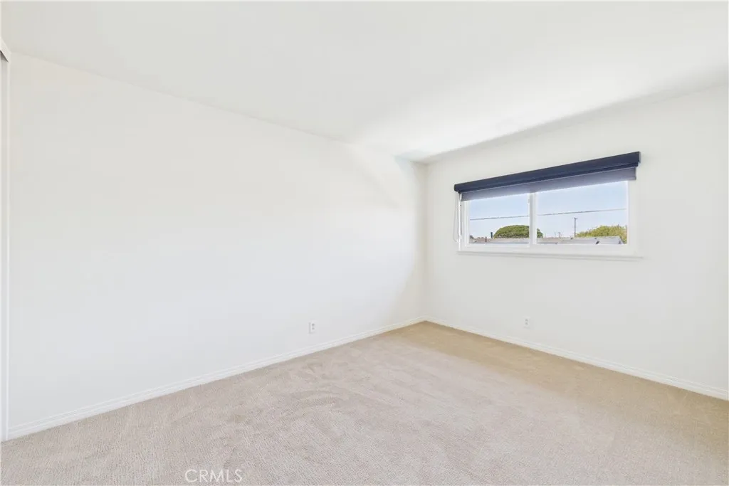 This bedroom is in the northwest area of the 3 additional bedrooms with a view of pool and backyard