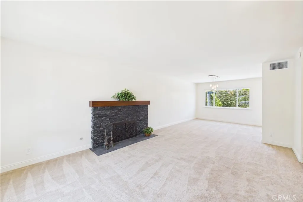 Unaltered original. Custom stacked stone fireplace in the living room