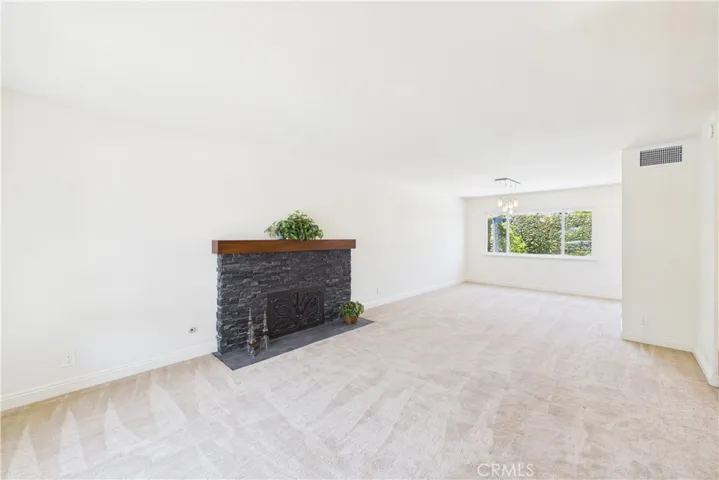Unaltered original. Custom stacked stone fireplace in the living room