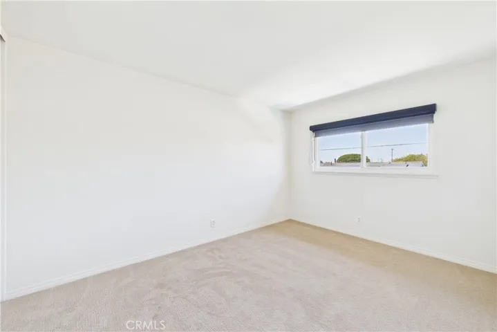 This bedroom is in the northwest area of the 3 additional bedrooms with a view of pool and backyard