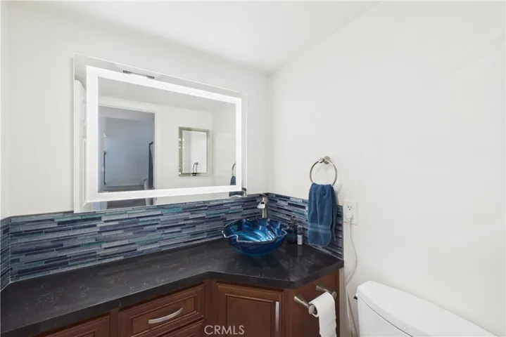 Powder bath with a lit mirror and Toto toilet