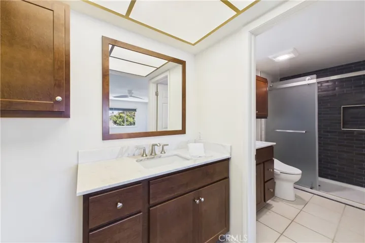 Recently (2026) remodeled primary bathroom with dual vanities and sinks, and custom tiled shower