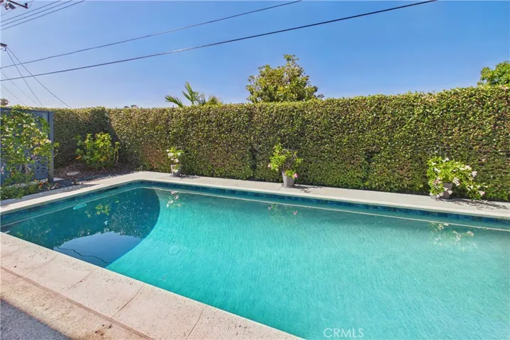 The pool equipment is tucked behind a trellis