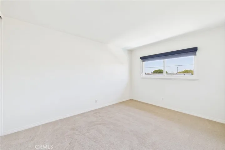 This bedroom is in the northwest area of the 3 additional bedrooms with a view of pool and backyard