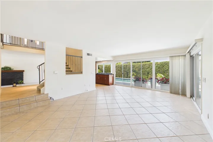 Wall to wall sliding glass doors provide light and great views of the pool and backyard