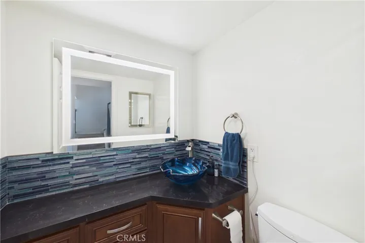 Powder bath with a lit mirror and Toto toilet