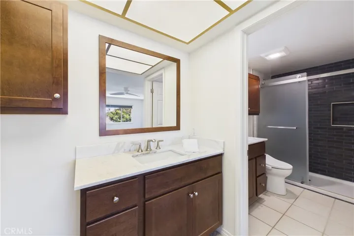 Recently (2026) remodeled primary bathroom with dual vanities and sinks, and custom tiled shower