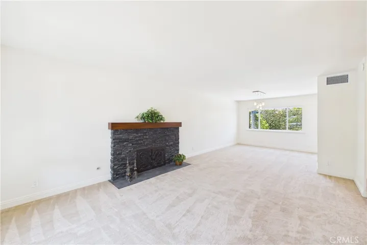 Unaltered original. Custom stacked stone fireplace in the living room