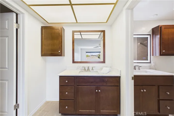 Vanity area with space for a hamper, more storage, or sitting area