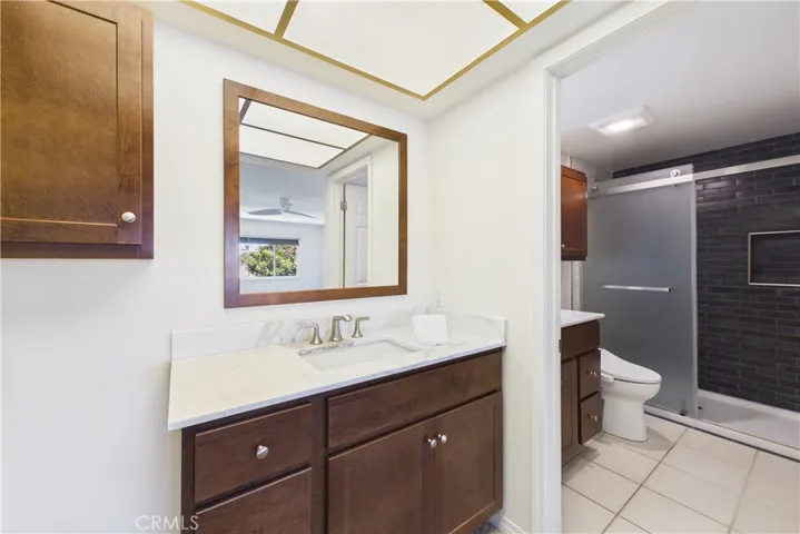 Recently (2026) remodeled primary bathroom with dual vanities and sinks, and custom tiled shower