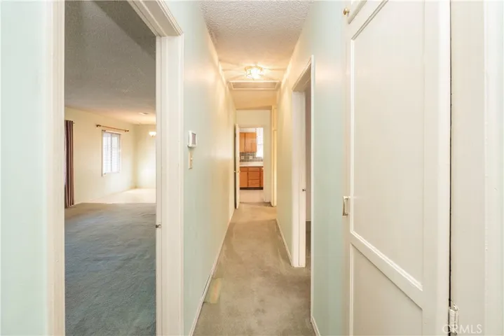 hallway leading to bedrooms and kitchen