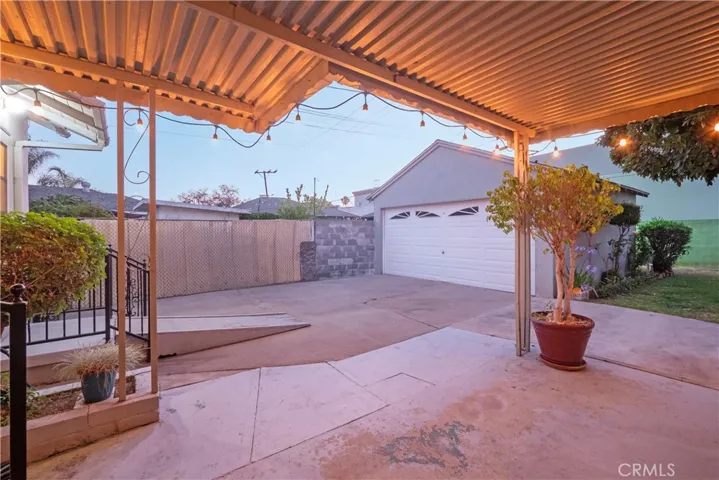 back patio showing 2-car garage behind
 gate