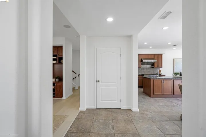 Tiled entryway featuring a painted two-panel door