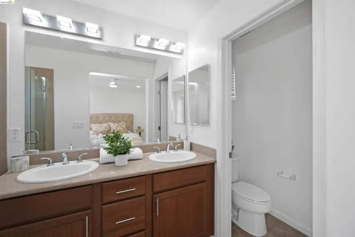 Double vanity with undermount sinks and chrome fixtures, set in a neutral-toned countertop