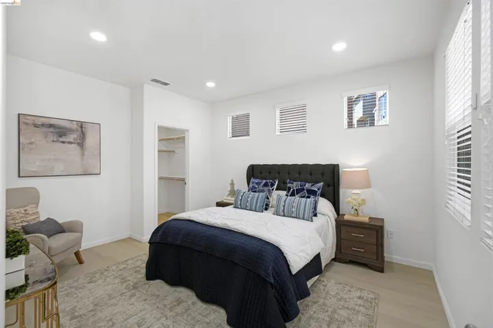 Bright interior featuring light wood-finish flooring, recessed lighting, and a closet with built-in shelving