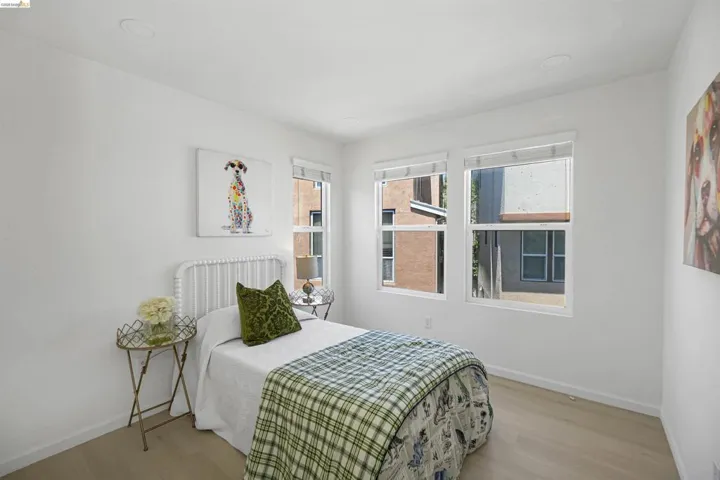 Light-toned wood-finish flooring complements white walls and recessed ceiling lighting