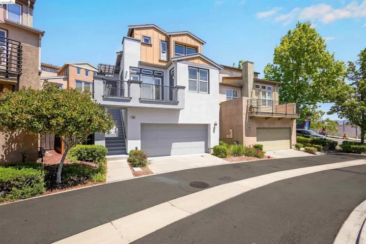 Multi-story townhome featuring a modern architectural design with varied exterior finishes