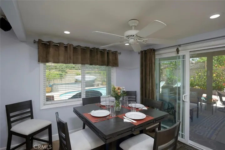 Informal dining area adjacent to kitchen, family room and rear yard oasis