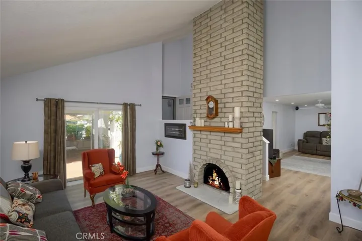 Living room with floor to ceiling fireplace offering ambience on crisp days and nights