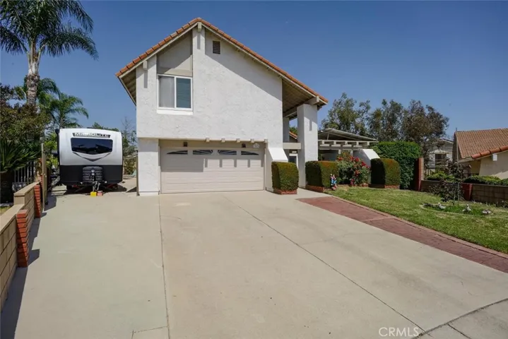 Spacious 10 ft by 27 foot RV parking area behind wrought iron gate