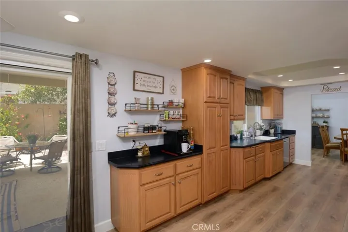 Remodeled kitchen with abundant counters and cabinetry featuring double door pantry and coffee center