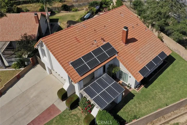 Aerial view of home displaying seller owned efficient solar panels