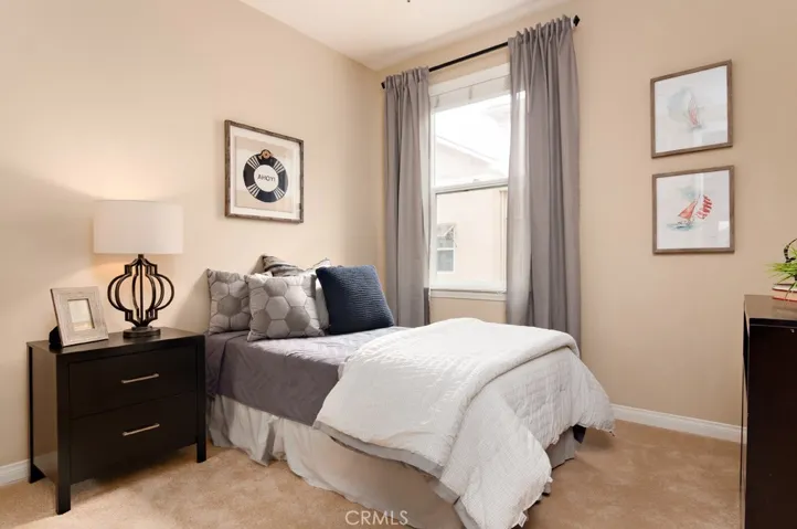Bright and inviting secondary bedroom designed to provide both comfort and privacy.