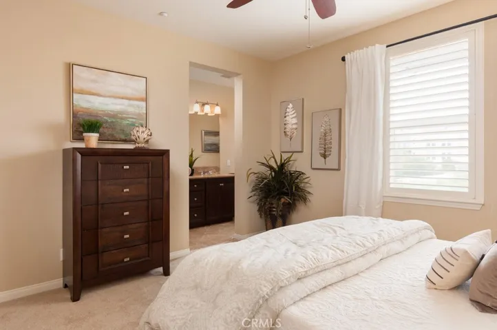 Spacious primary suite provides a peaceful retreat with abundant natural light and relaxing comfort.