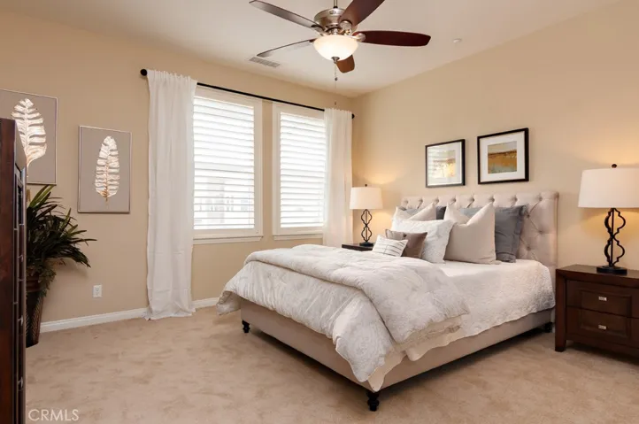Spacious primary bedroom offers a tranquil atmosphere with plenty of room to unwind and recharge.