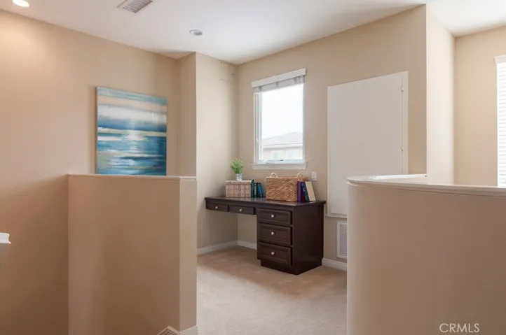 Versatile landing area ideal for a home office, reading nook, or additional flex space.