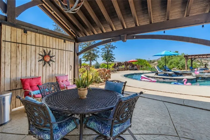 View of the resort style pool from the covered outdoor kitchen