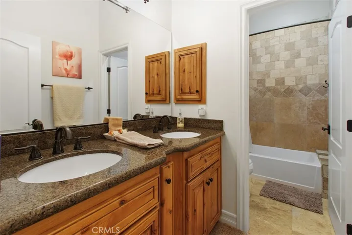 Secondary bathroom with dual sinks, tub & shower