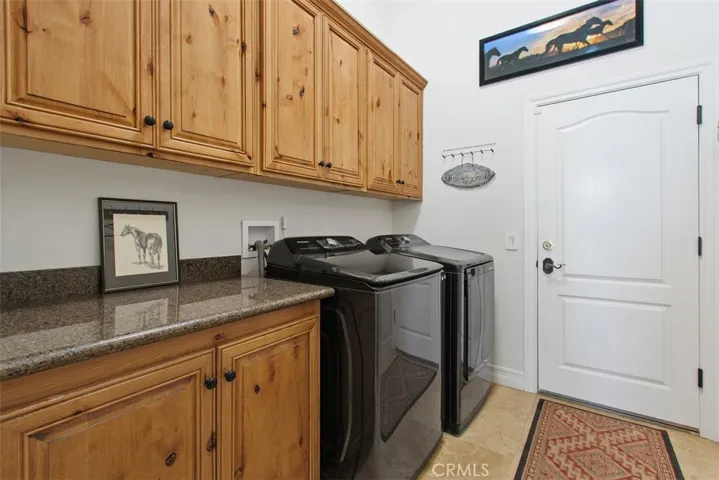 Laundry room with cabinetry and folding counter