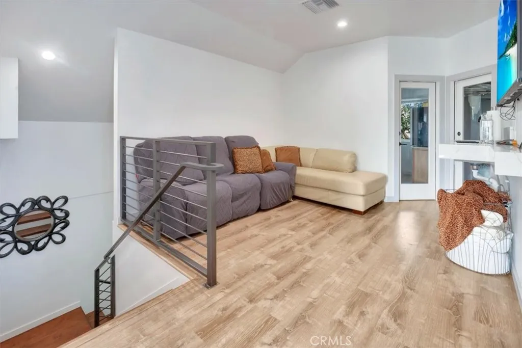Coming up the stairs to a large full, extended suite with living options. To left is loft area and two doors. Right door to large walk-in closet. Left door to optional 4th bedroom being used as a wrap-around office.