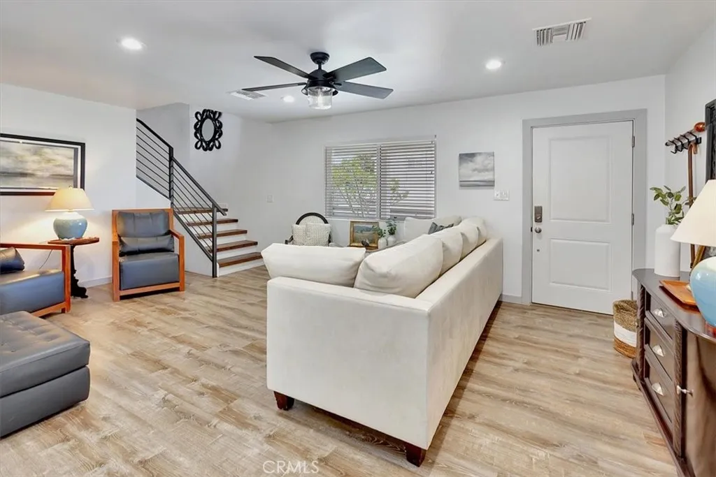 Front Entry to Living Room and open concept kitchen with expansive custom cabinetry and storage.