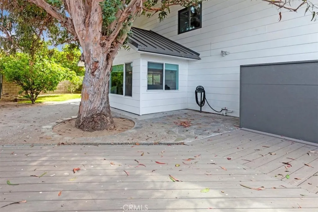 Left/east side of home wraps around to a rear veranda.
