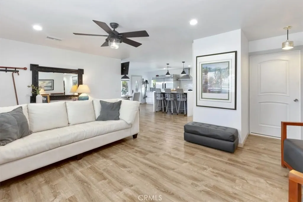 Open concept Living open to kitchen and dining and dining and entertaining flow of space. Rear door leading out to wrap-around patio, yard and rear veranda.
