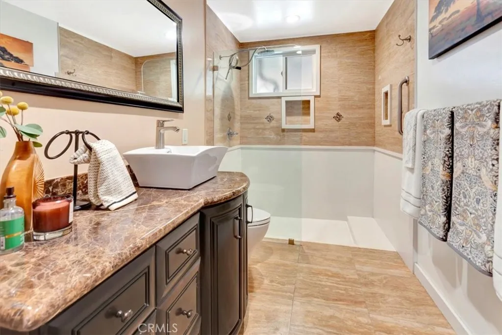 Downstairs three-quarter bath with walk-in shower and (unseen) tall cabinet for linens and storage.