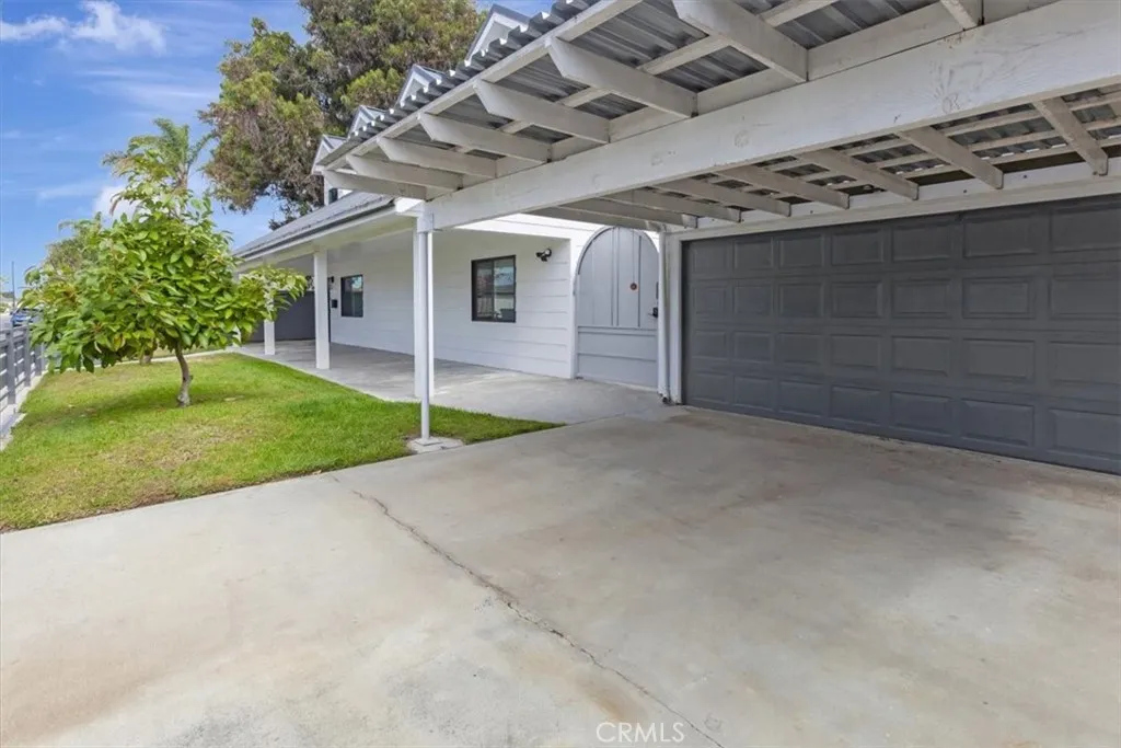 Permitted two-car carport space in front of original garage. Original garage is currently configured for flex and overflow space and has full-size side-by-side laundry, utility sink and a finished three-quarter bath, not included in living square footage.