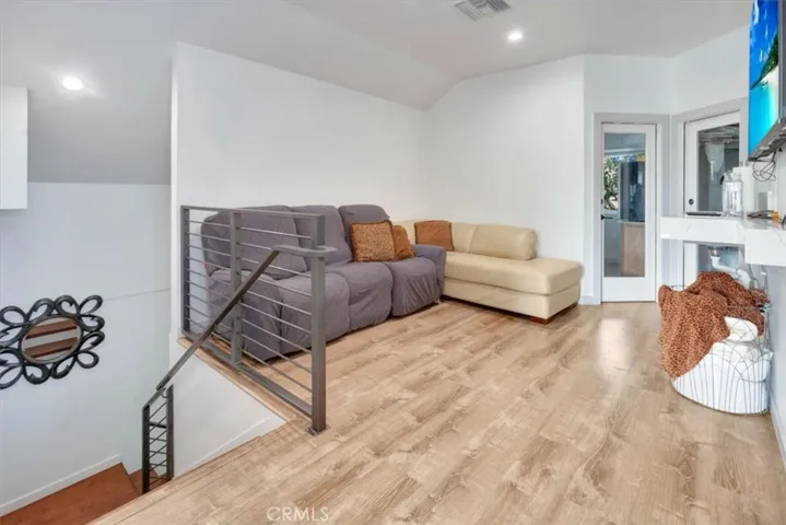Coming up the stairs to a large full, extended suite with living options. To left is loft area and two doors. Right door to large walk-in closet. Left door to optional 4th bedroom being used as a wrap-around office.