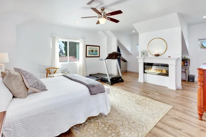 Electric fireplace and behind is an storage closet space that can be enclosed but is currently used as open flow.