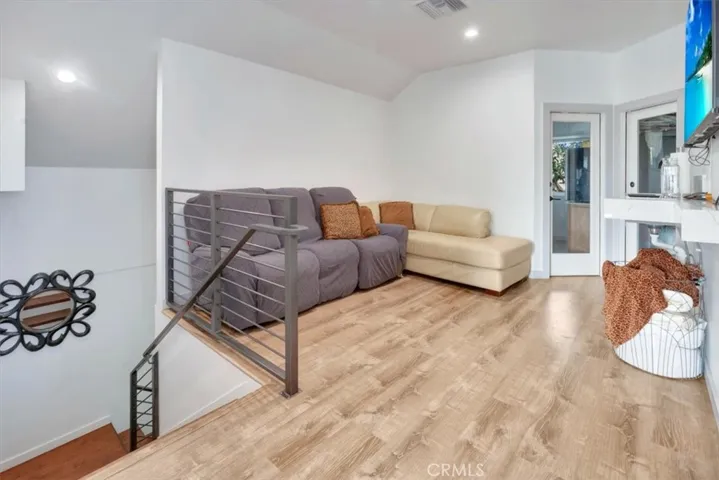 Coming up the stairs to a large full, extended suite with living options. To left is loft area and two doors. Right door to large walk-in closet. Left door to optional 4th bedroom being used as a wrap-around office.