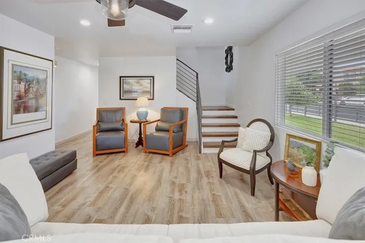 Hall to left of living room leads to hall three-quarter bath and two bedrooms.