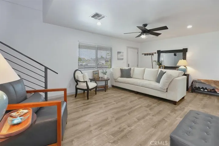Up the custom industrial stairs to Primary Suite with fireplace and balcony, Media Loft, and optional 4th bedroom used as an office.